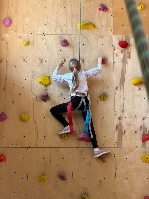 Children rock climbing at indoor facility in Izhevsk