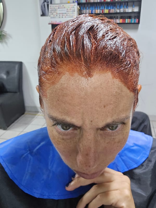 Woman gets hair dyed auburn, manicure at Peru salon