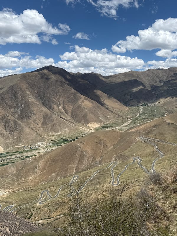 Mountainous landscape with winding road documented near Lhasa