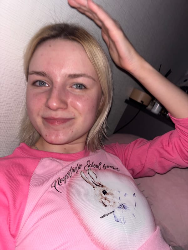 Woman in pink shirt observed indoors in Russia