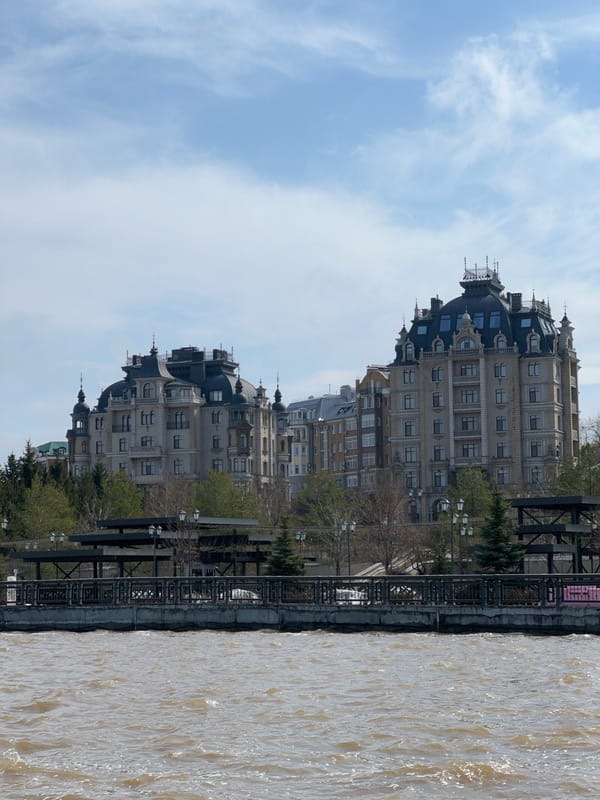 Woman photographs morning outing near Kazan waterfront landmarks