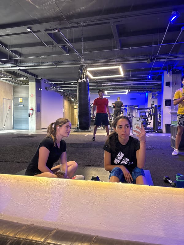 Gym selfie captures women and others during workout session