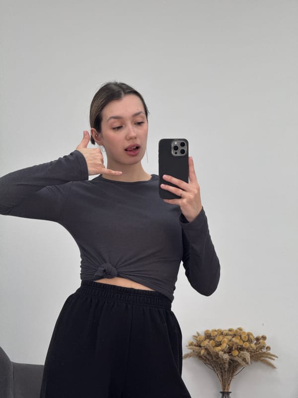 Woman Takes Horizontal Selfie in Dark Knotted Top
