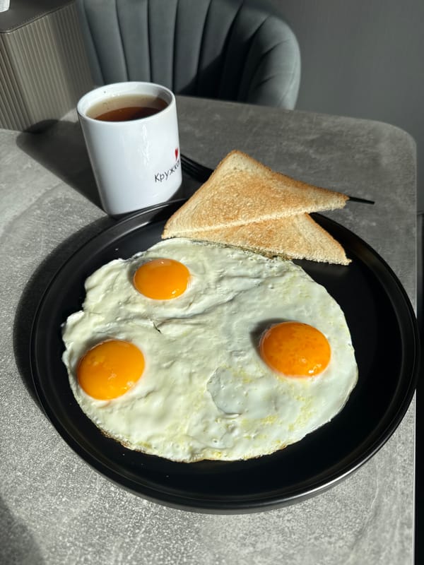 Breakfast documented in Lyubertsy: eggs, toast, dark beverage