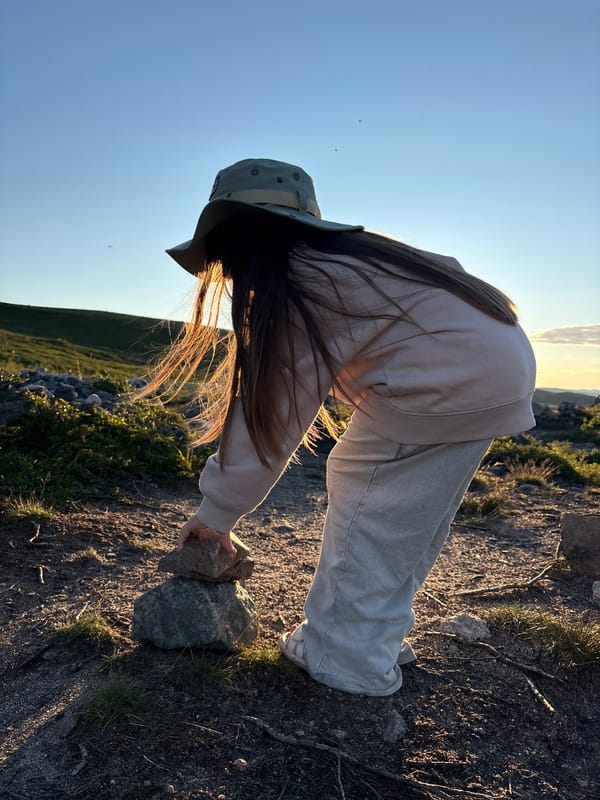 Stone stacking and sunset on a rocky Russian landscape