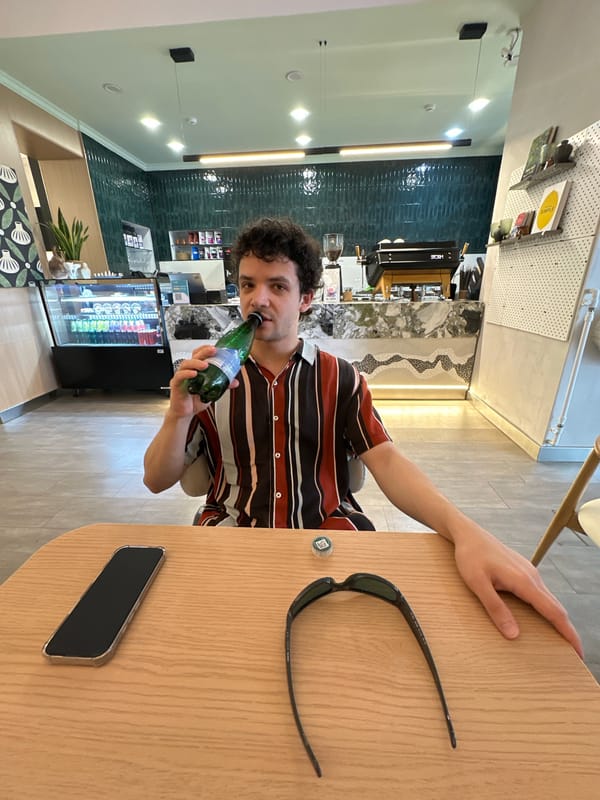 Two men enjoy beverages at Tashkent cafe