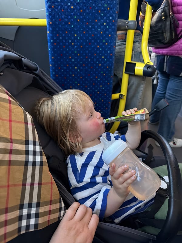 Child rests in stroller on public bus in northern Italy