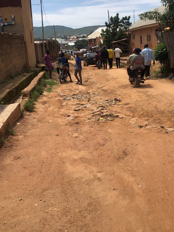 Unpaved street conditions documented with potholes and drainage infrastructure