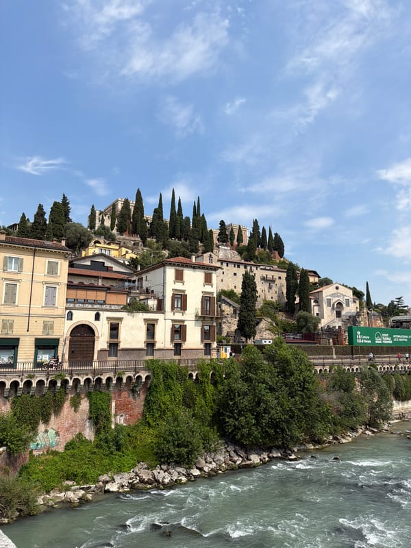Adige River and Verona's historic riverfront on a summer afternoon