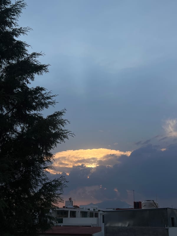 Golden sunlight illuminates dramatic cloud formation over Cholula, Mexico
