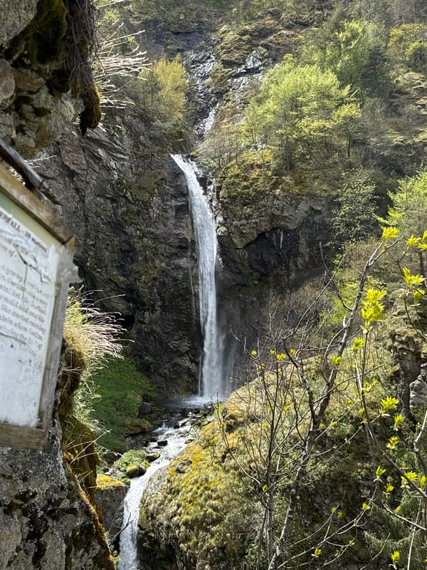 Tourists photograph at Bulgarian waterfall during spring visit