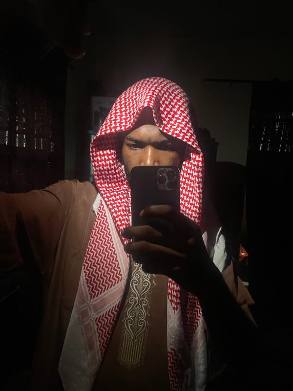 Person takes smartphone selfies in traditional dress, Lokoja Nigeria
