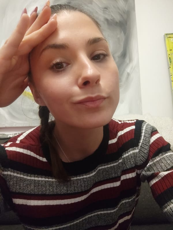 Woman takes selfie in striped sweater in Razgrad, Bulgaria