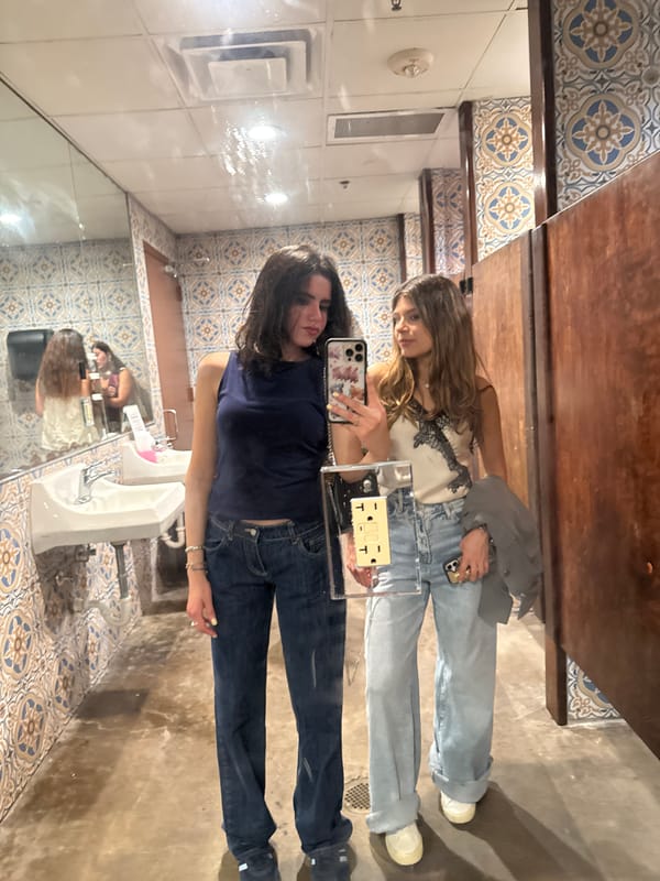 Two women take selfie in College Station public restroom