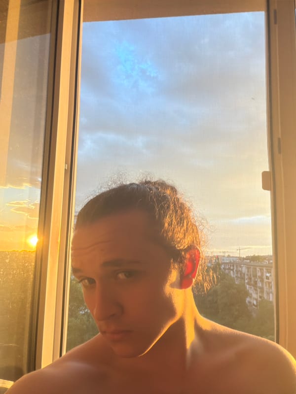 Person captures sunset selfies overlooking Plovdiv cityscape