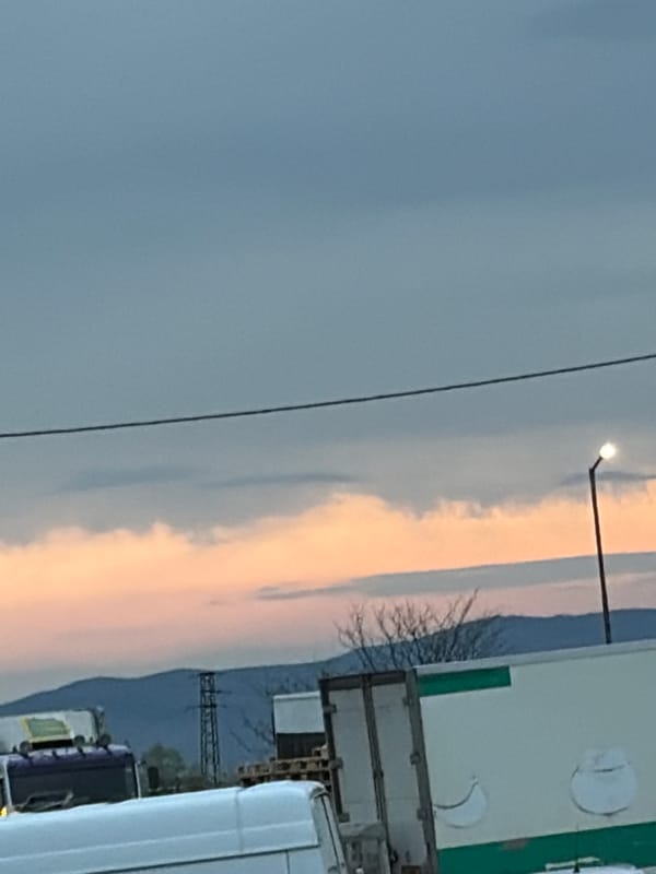 Sunrise or sunset sky captured over industrial landscape