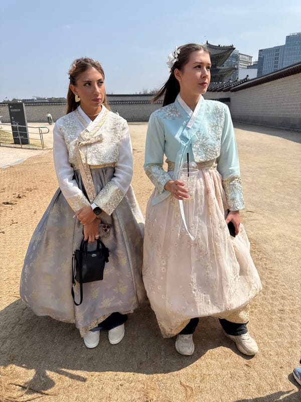 Tourists in traditional Korean dress visit Gyeongbokgung Palace
