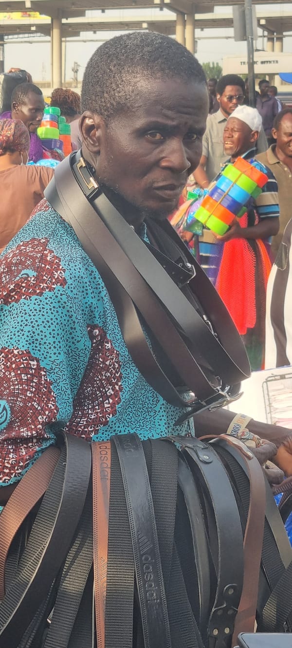 Street vendor sells counterfeit belts in busy Ikeja market