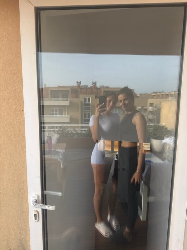 Two women reflected in glass door, Vila Nova de Gaia
