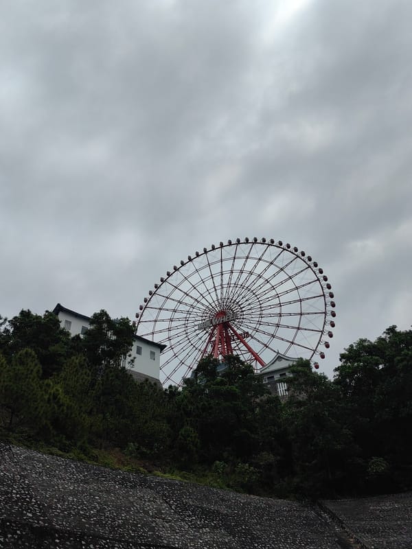 Red Ferris wheel spotted on hillside in Hong Gai Ward