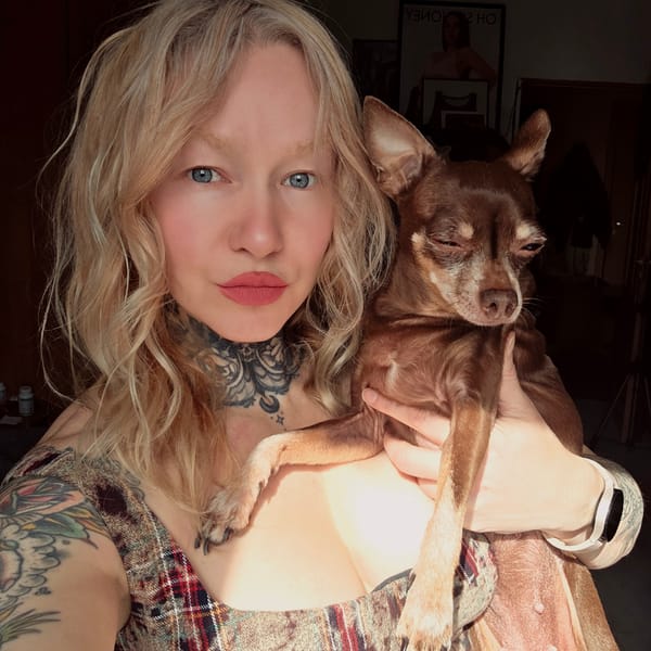 Woman poses with sleeping Chihuahua in Saint Petersburg