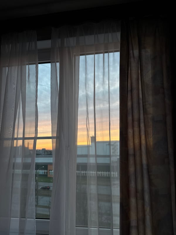 Resident captures sunset cityscape views through window in Saint Petersburg
