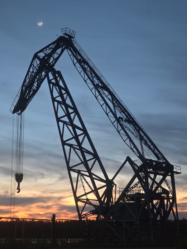 Construction crane silhouetted against evening sky in Ruse, Bulgaria
