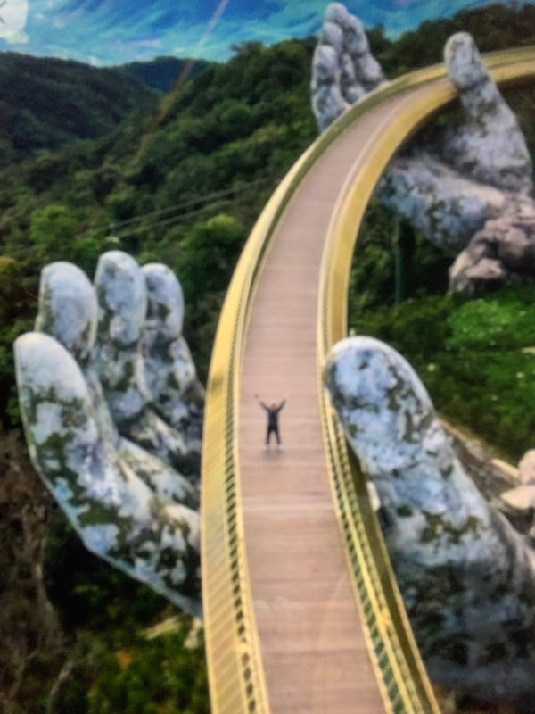 Tourists pose and relax at Vietnam's Golden Bridge attraction