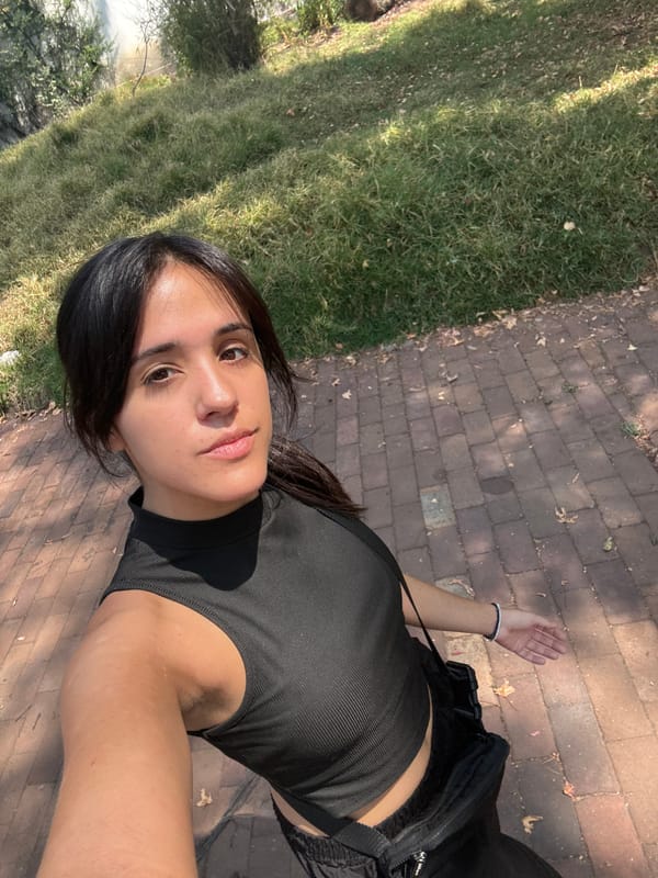 Woman takes selfie in Mexico City park on sunny afternoon