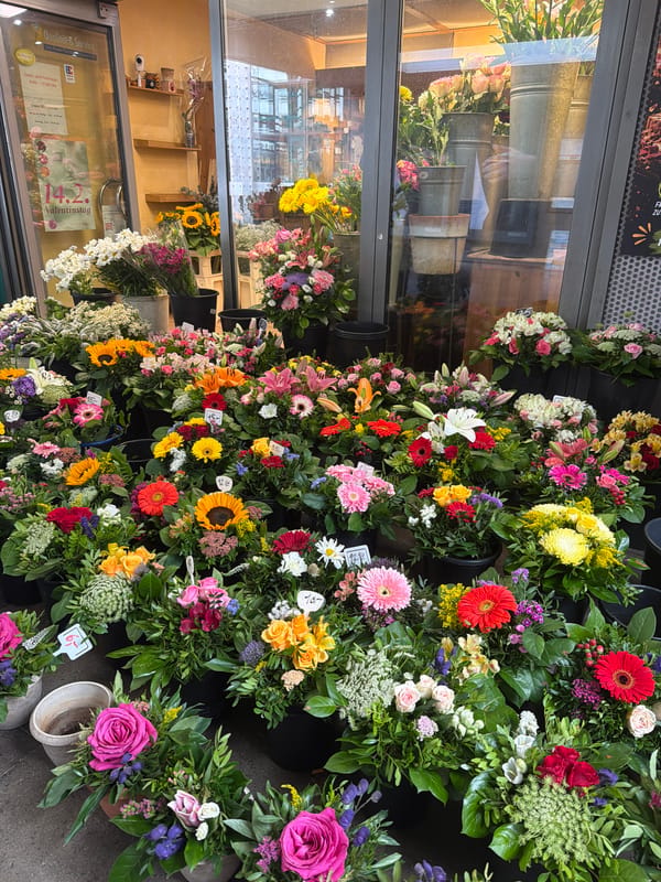 Florist stand beside a construction-blocked subway staircase