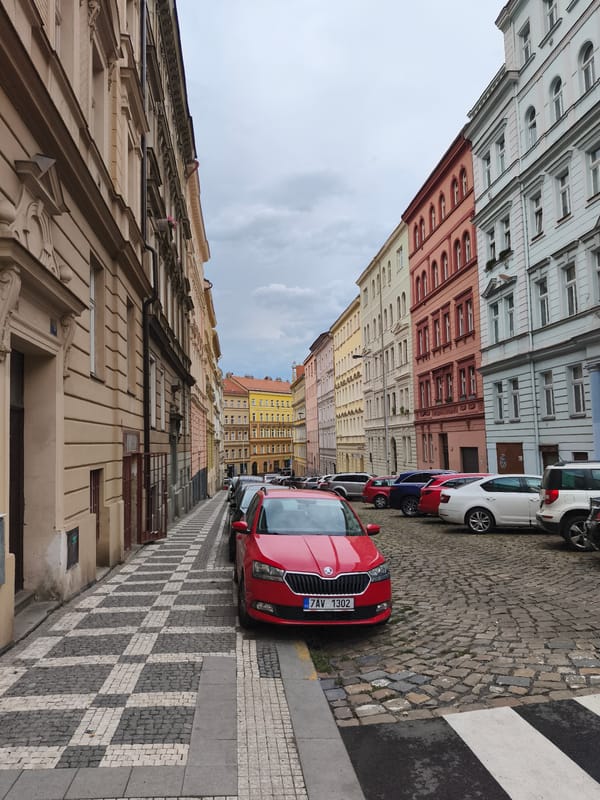 Cobblestone street cuts through Prague's historic colorful old quarter