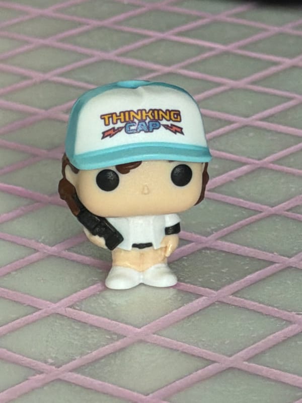Funko Pop figurines and quirky desk items up close