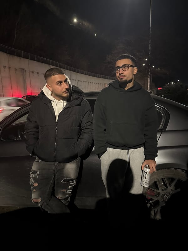 Two men pose for photo near car in Varna