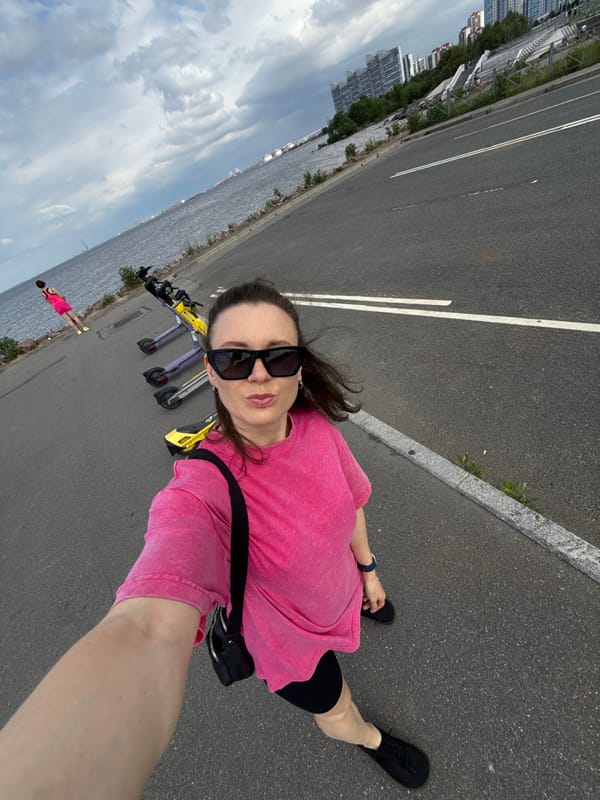 Woman Takes Multiple Selfies Along Saint Petersburg Waterfront Promenade