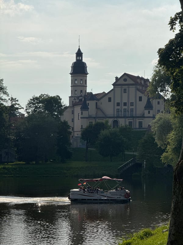 Afternoon at Nesvizh Castle: grounds, lake, and an outdoor event