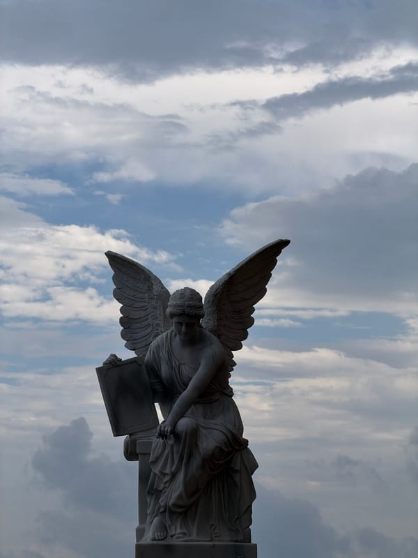 Angel statue photographed against dramatic sky in Đà Nẵng