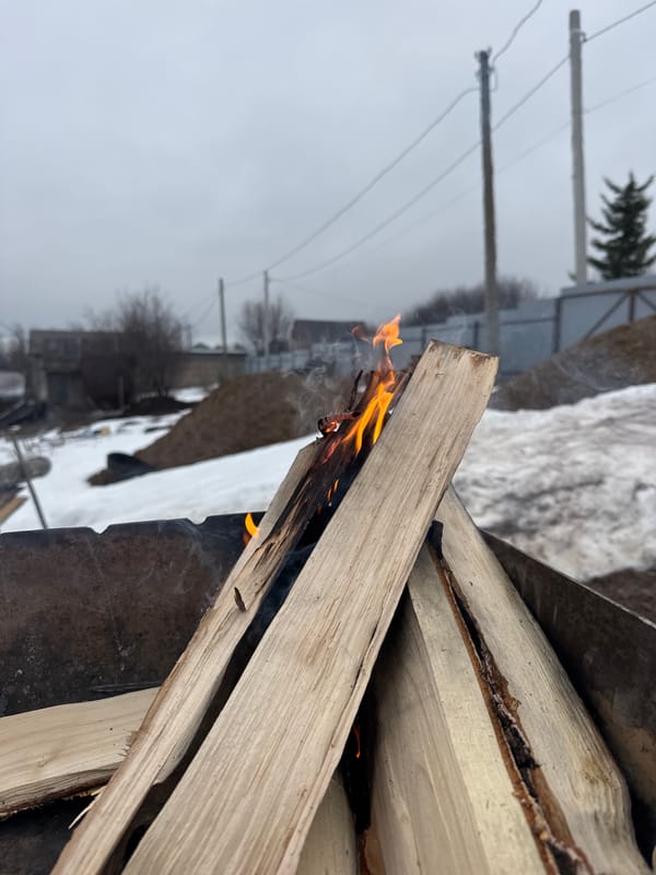 Small outdoor fire burns in metal pit in Chaikovsky
