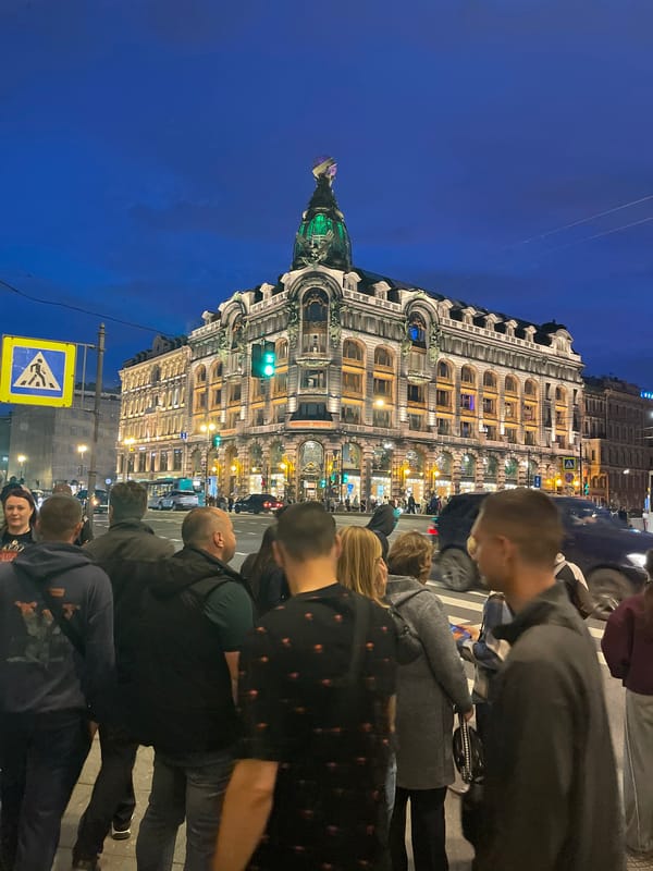 Dusk crowd outside a domed landmark in Saint Petersburg