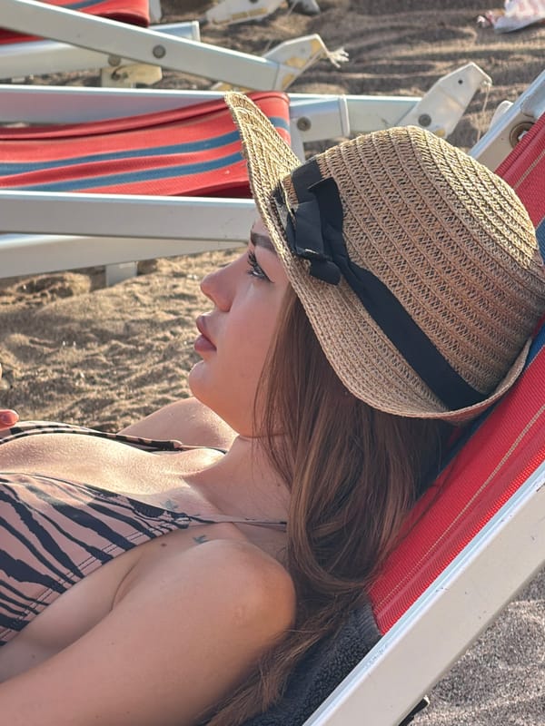 Woman enjoys late afternoon beach time in Boreti, Montenegro