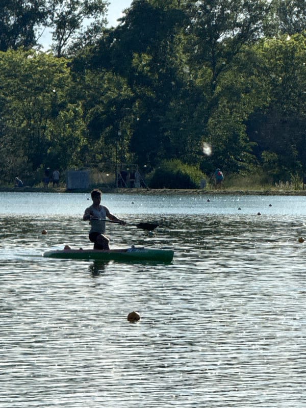 Recreational watercraft activity observed on sunny lake afternoon