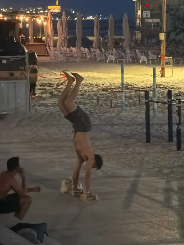 Tel Aviv beachfront captured at dusk with city skyline