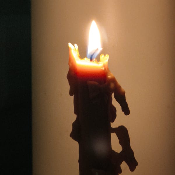 Masked individual documents candle, knife in Belarus apartment