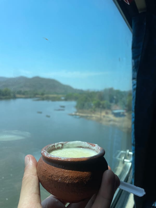 Person enjoys yogurt from clay pot in Dasgaon