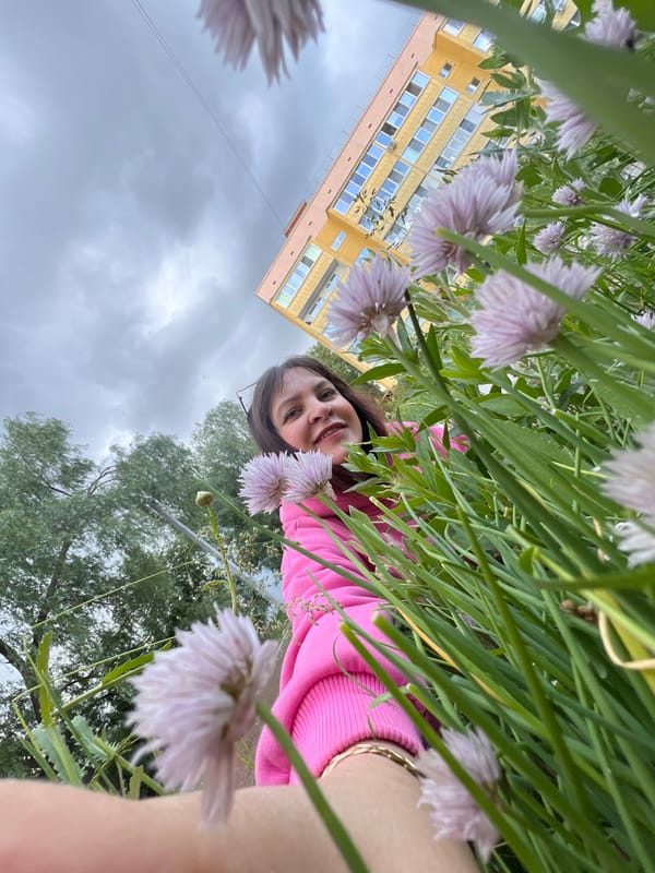 Woman photographed smiling among purple flowers in Noviy, Russia