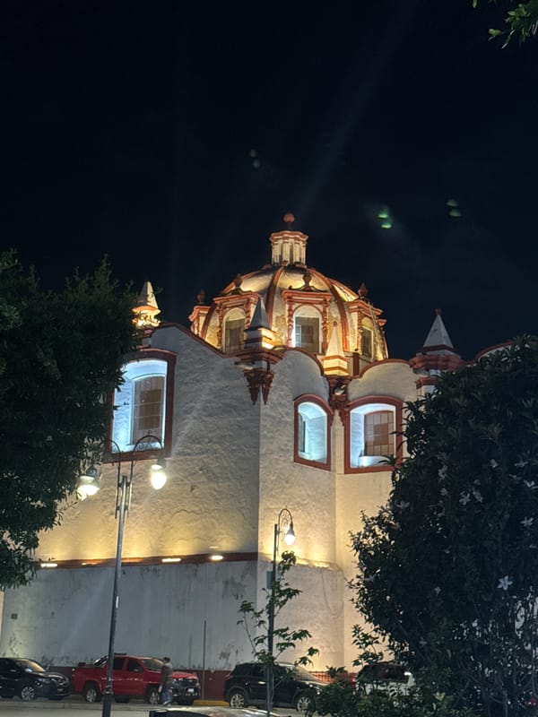 Church building photographed at night in Cholula, Mexico