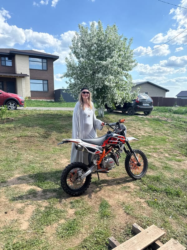 Two people pose with dirt bike in Izhevsk