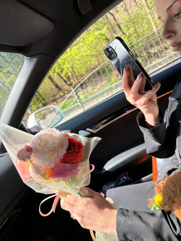Woman with flowers and dog photographed in Sofia car