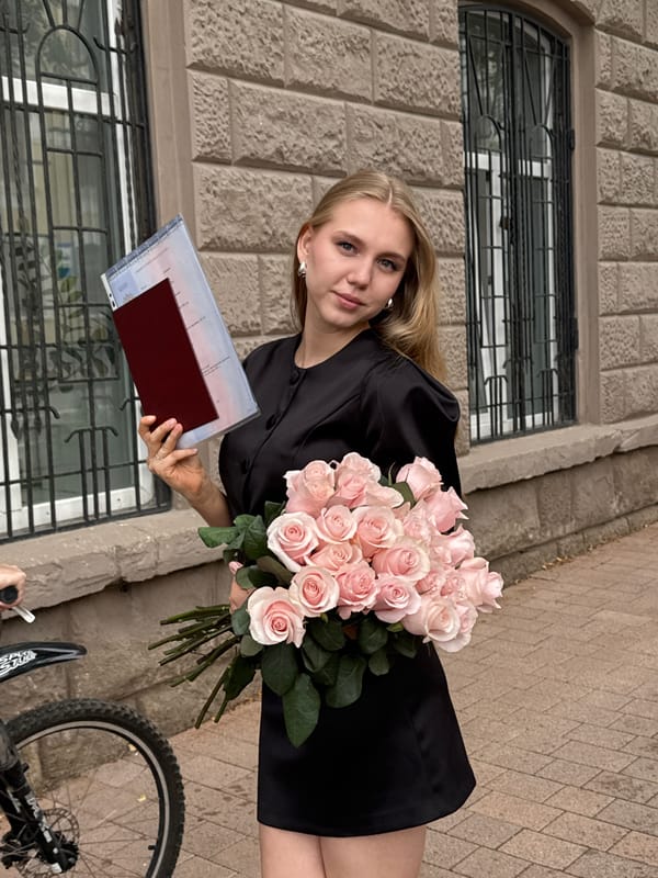Graduation day in Perm, roses and diploma in hand