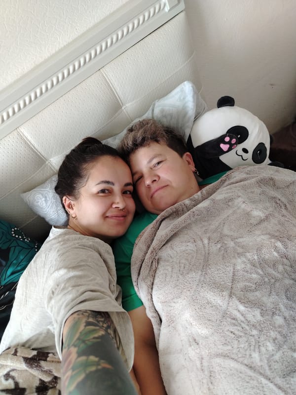 Lazy morning in bed with a pink orchid nearby