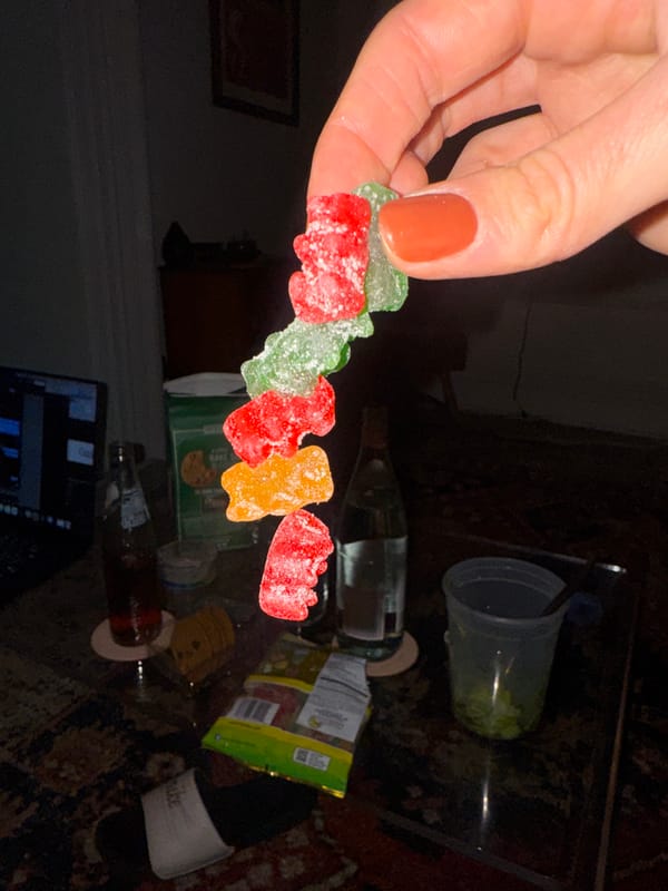 Late-night snacking scene captured over cluttered New York coffee table